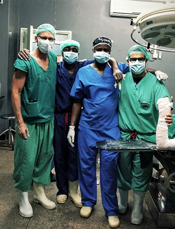 Dr. E. Bruce Toby, Dr. Edgar Araiza, and surgery residents in operating room in Tanzania