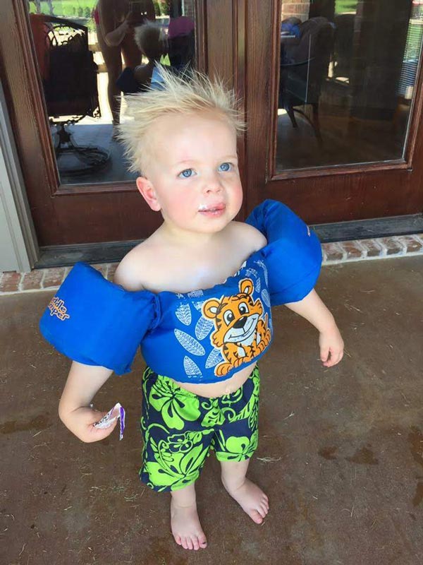Toddler Gavin Lee Robbins in floaties and swimsuit.