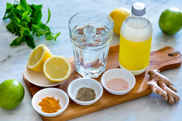 Water, lemon, ginger, and spices line up for ginger recipes.