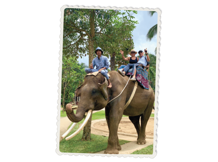 The Barulich's ride an elephant while on vacation