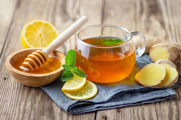 cup of mint tea with lemon, ginger and honey; health benefits of floral tea
